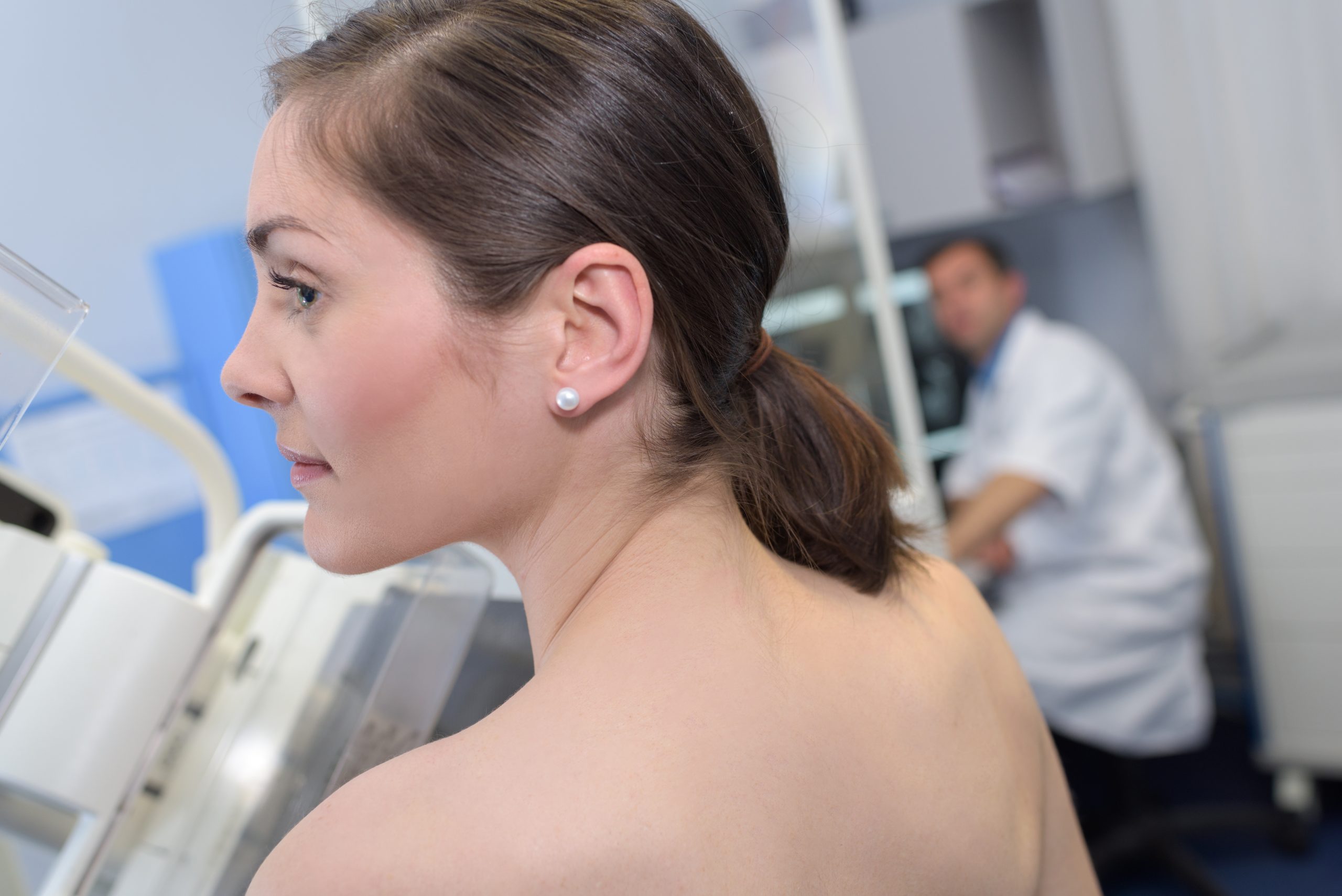 A photograph of a woman’s profile in a doctor’s office.
