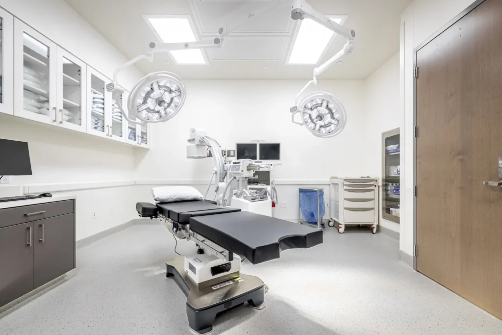 A bright, modern operating room at ReCenter Breast Cancer Hospital features advanced equipment and a welcoming atmosphere.