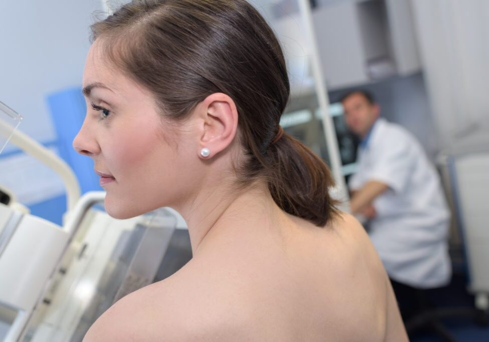 A photograph of a woman’s profile in a doctor’s office.