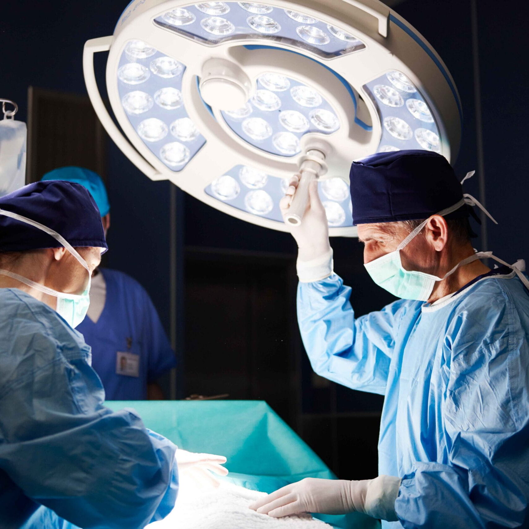 Surgeons perform a breast cancer procedure in a modern operating room at ReCenter in Baton Rouge, using advanced surgical technology and patient-focused care.